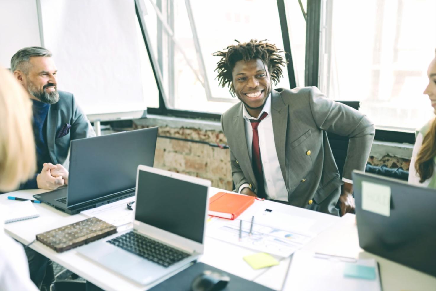 Workshop participants reviewing search ranking data on multiple screens